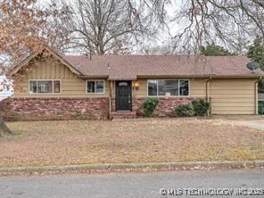 ranch-style home featuring a garage, driveway, and board and batten siding