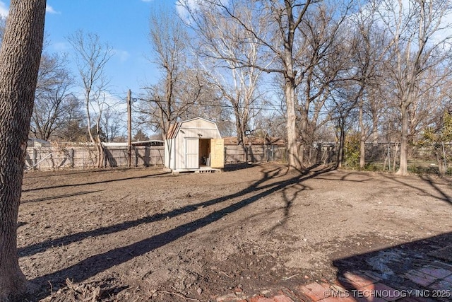 view of yard with a storage shed, a fenced backyard, and an outdoor structure