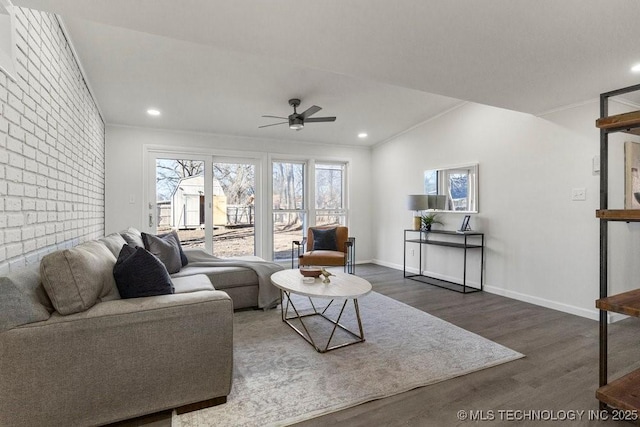 living area with a healthy amount of sunlight, crown molding, baseboards, and wood finished floors