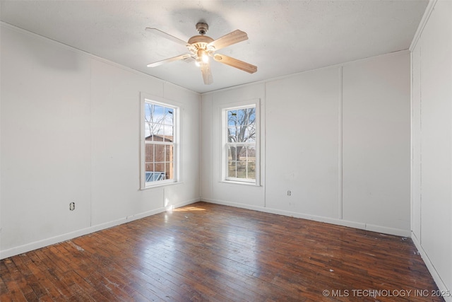 spare room with a ceiling fan, wood-type flooring, ornamental molding, and baseboards