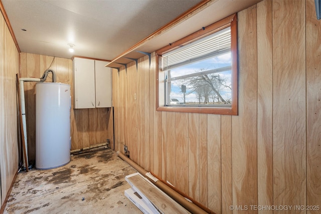 basement with gas water heater and wood walls