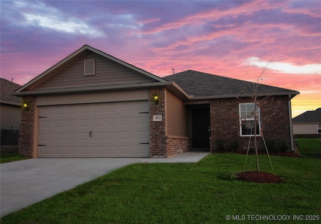 single story home featuring central AC unit, a garage, brick siding, concrete driveway, and a front yard