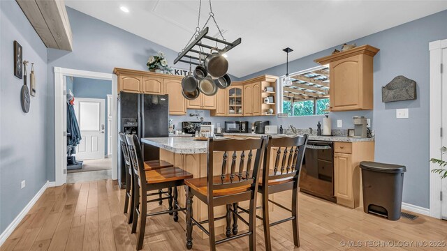 36953 US Highway 70, Bennington, OK 74723 - kitchen featuring black appliances, light countertops, baseboards, a kitchen bar, and high vaulted ceiling