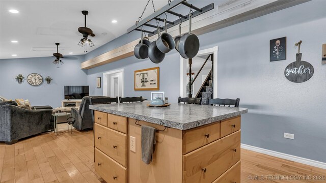 36953 US Highway 70, Bennington, OK 74723 - kitchen with light brown cabinetry, ceiling fan, light wood-type flooring, open floor plan, and a center island