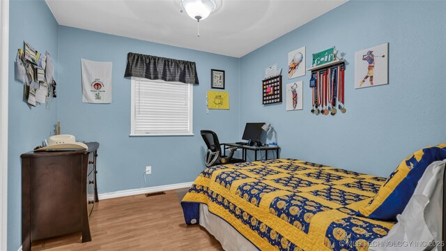 36953 US Highway 70, Bennington, OK 74723 - bedroom featuring wood finished floors, baseboards, and a ceiling fan