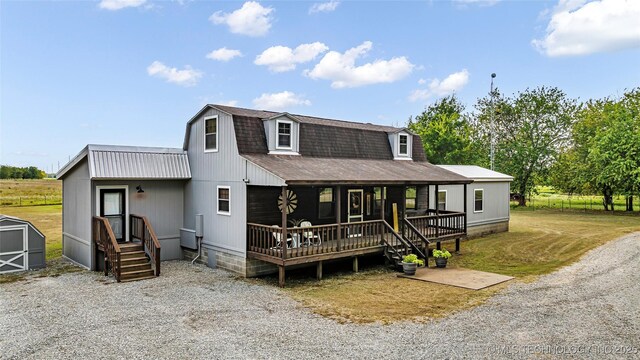 36953 US Highway 70, Bennington, OK 74723 - colonial inspired home featuring covered porch, a gambrel roof, and a shingled roof