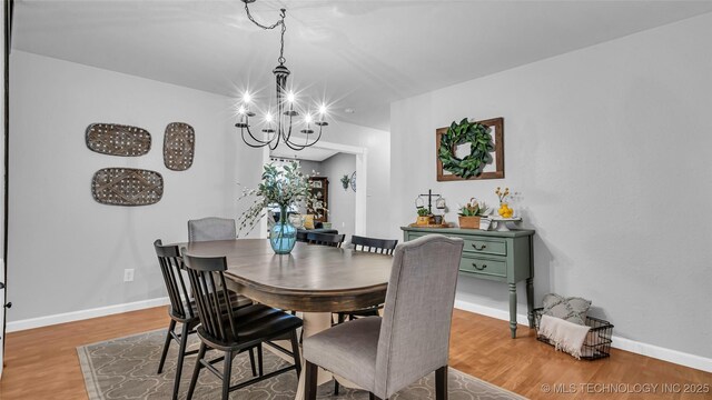 36953 US Highway 70, Bennington, OK 74723 - dining room with a chandelier, light wood-style floors, and baseboards