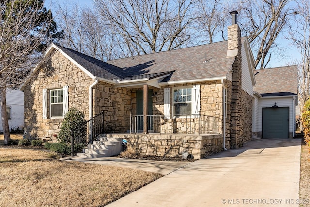 view of front of property featuring a chimney, a shingled roof, a garage, stone siding, and driveway