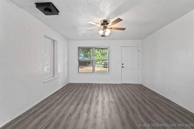 spare room with a textured ceiling, a ceiling fan, and wood finished floors