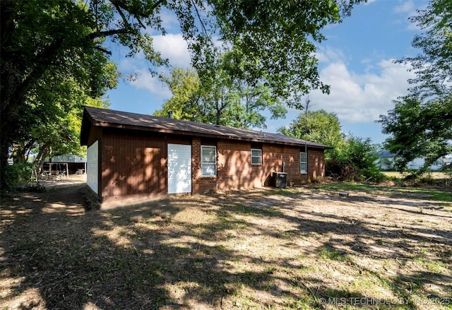 back of house with central AC unit