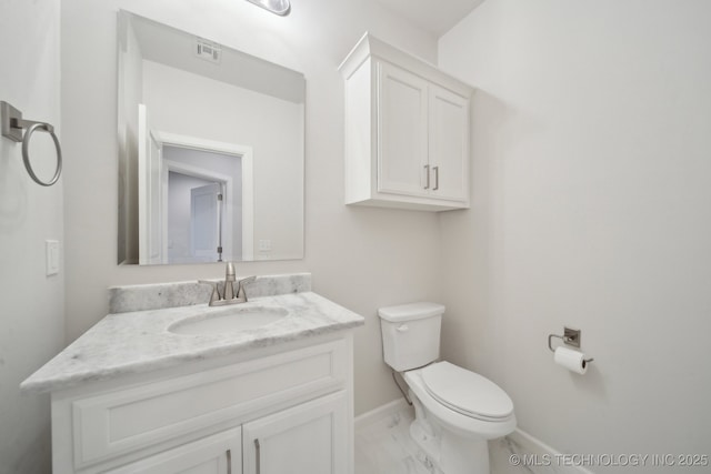 half bathroom with toilet, visible vents, vanity, baseboards, and marble finish floor