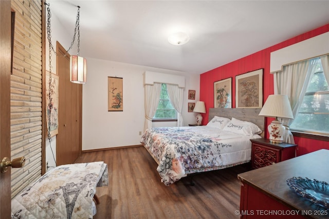 bedroom with baseboards and wood finished floors