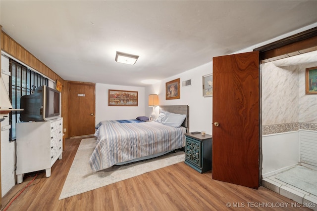 bedroom with visible vents and wood finished floors