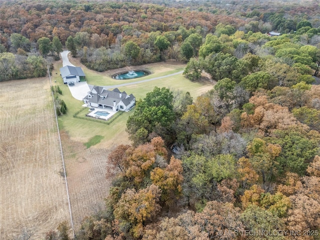 birds eye view of property with a wooded view