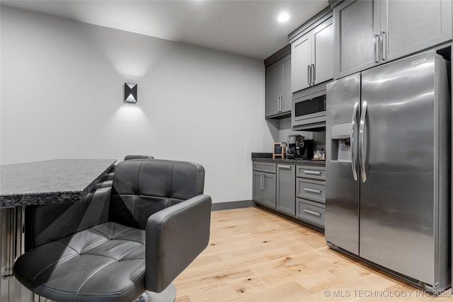 interior space featuring light wood finished floors, recessed lighting, and baseboards