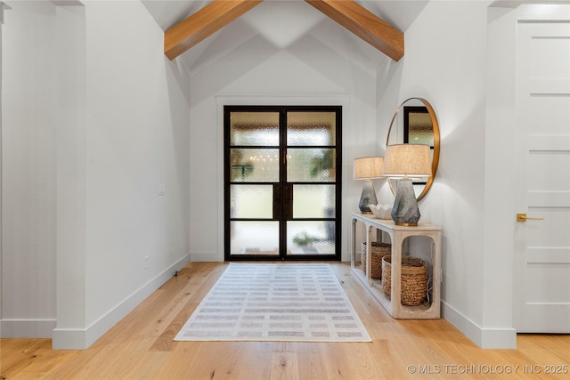 doorway with lofted ceiling with beams, baseboards, and light wood-style floors