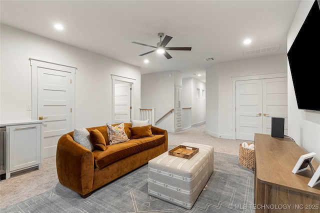 living room with recessed lighting, visible vents, a ceiling fan, and light colored carpet