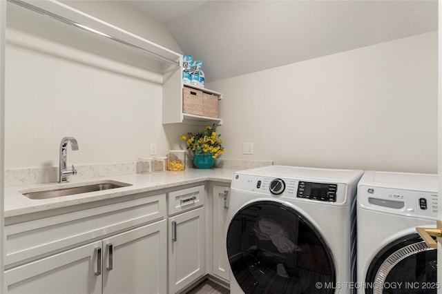 laundry area with cabinet space, a sink, and independent washer and dryer