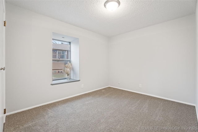 carpeted empty room with baseboards and a textured ceiling