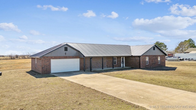 ranch-style home with driveway, a garage, metal roof, a front lawn, and brick siding