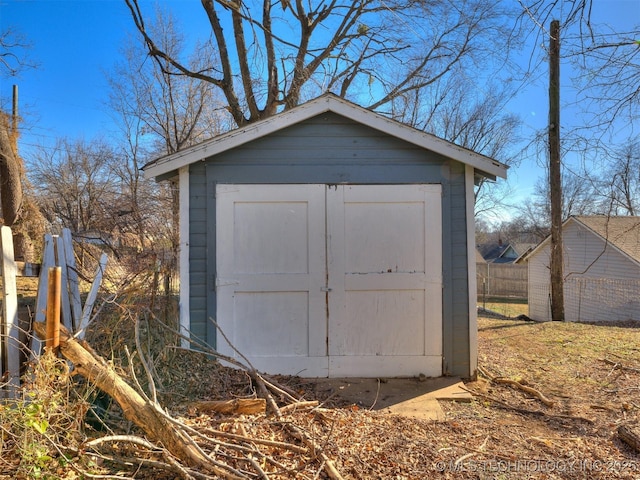 view of shed featuring fence