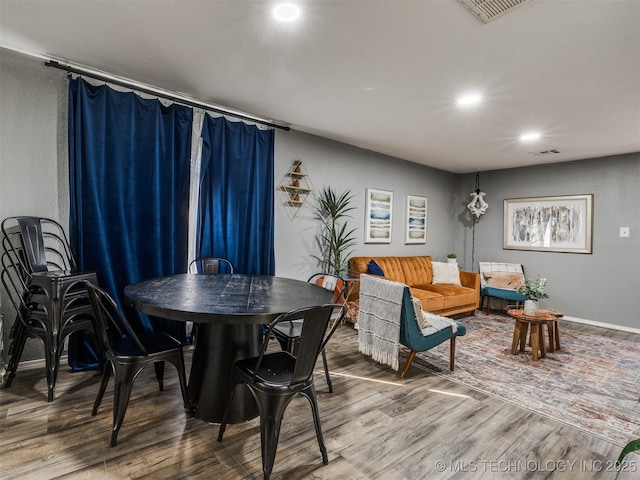 dining room with visible vents, baseboards, and wood finished floors