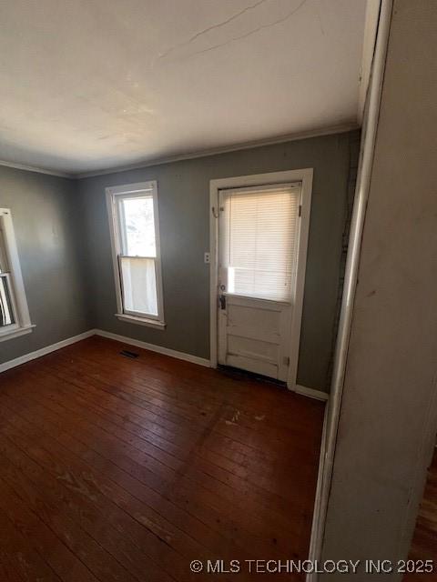 entrance foyer with baseboards, ornamental molding, and dark wood-type flooring