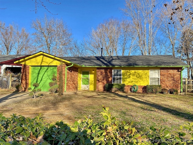 ranch-style home with a garage, concrete driveway, and brick siding