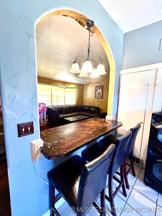 kitchen with an inviting chandelier and tile patterned flooring