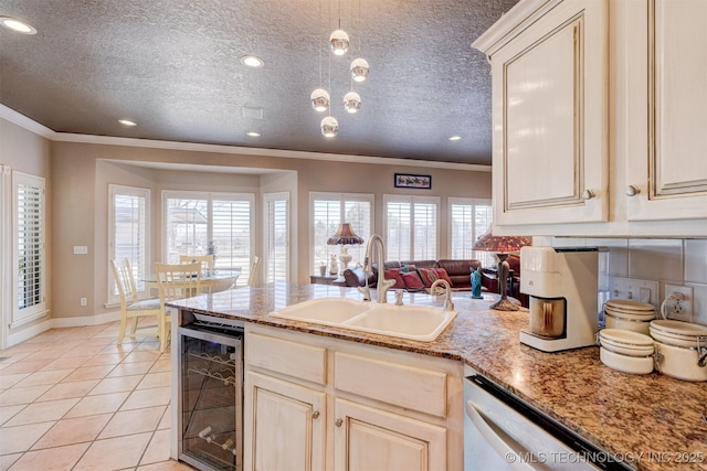 kitchen featuring light tile patterned floors, wine cooler, a sink, ornamental molding, and dishwasher