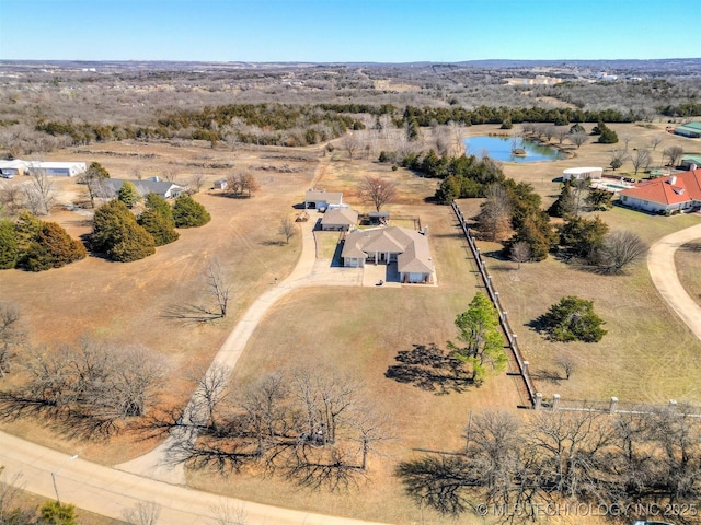 birds eye view of property with a water view and a rural view