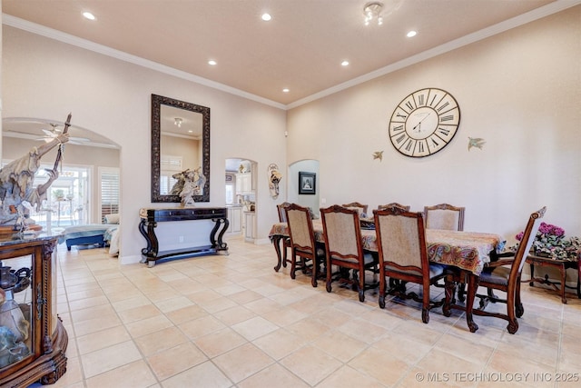 dining room featuring arched walkways, ceiling fan, light tile patterned floors, recessed lighting, and crown molding