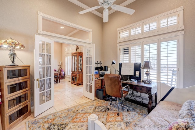 office space with a ceiling fan, tile patterned flooring, a high ceiling, crown molding, and french doors