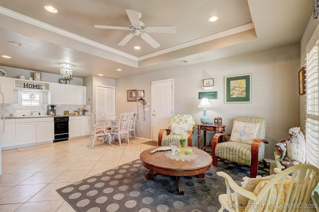 living area with light tile patterned floors, a raised ceiling, and crown molding