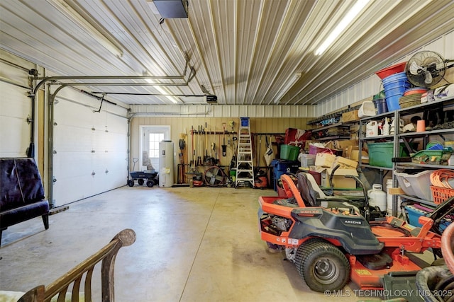 garage with water heater, metal wall, and a garage door opener