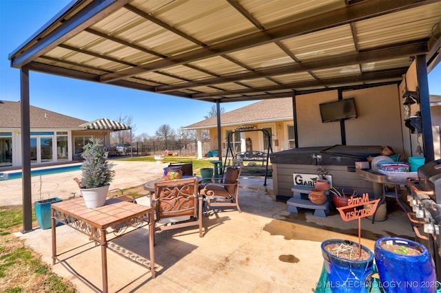 view of patio featuring an outdoor pool and a hot tub