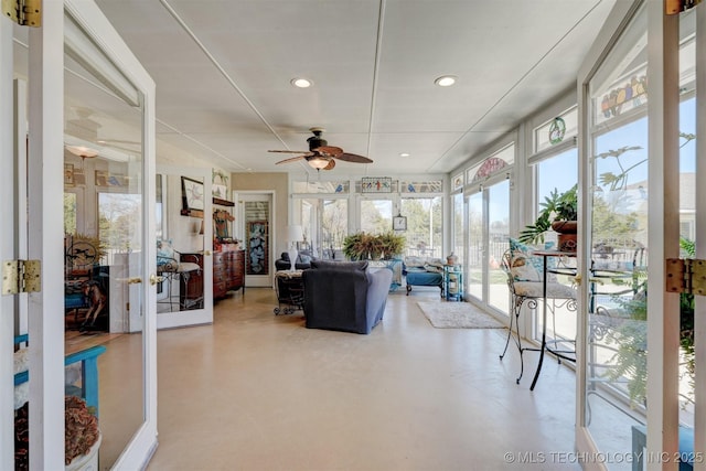 sunroom with ceiling fan and french doors