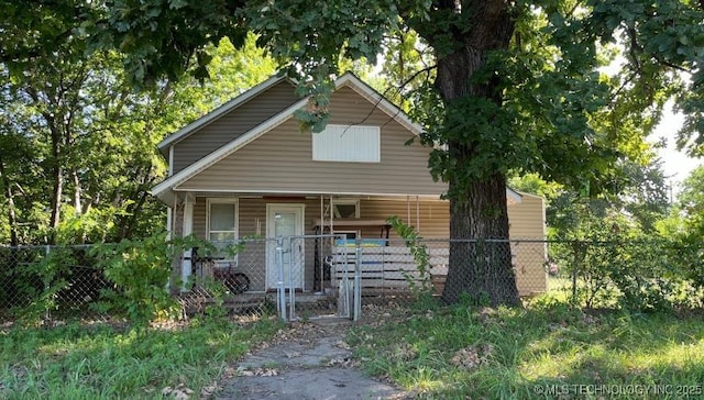 view of front facade featuring a fenced front yard, a gate, and a porch