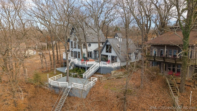 rear view of house featuring stairway and a wooden deck