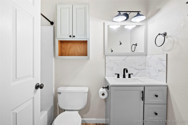 full bathroom featuring toilet, backsplash, and vanity