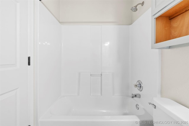 bathroom with toilet and  shower combination