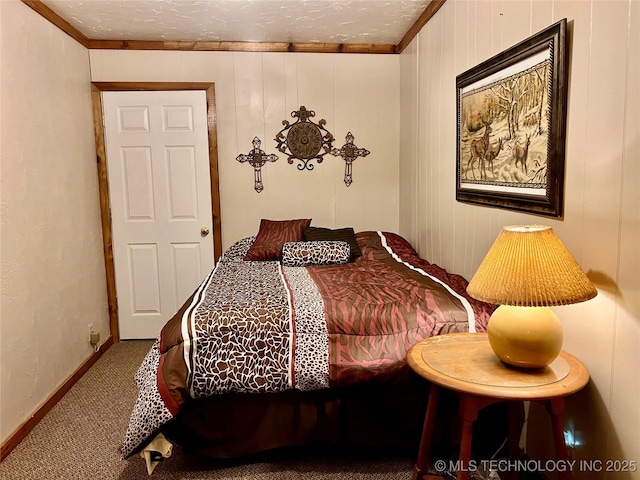 bedroom featuring a textured ceiling, carpet floors, crown molding, and baseboards