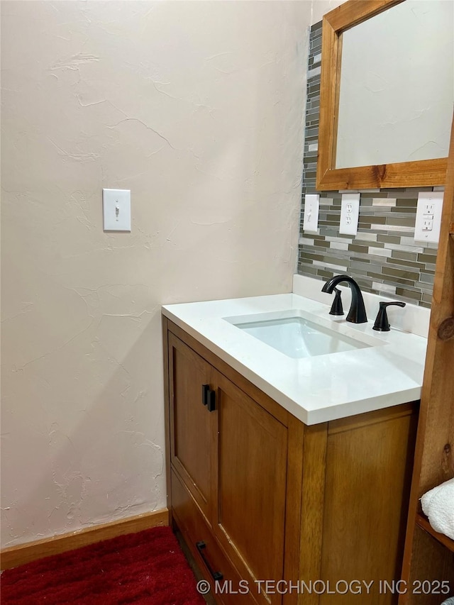 bathroom with tasteful backsplash and vanity