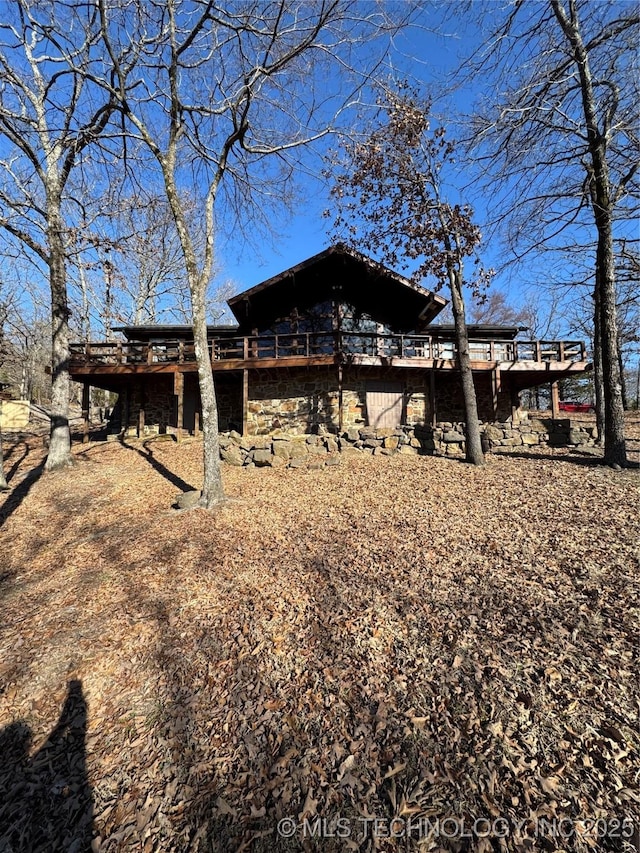 rear view of house with a wooden deck