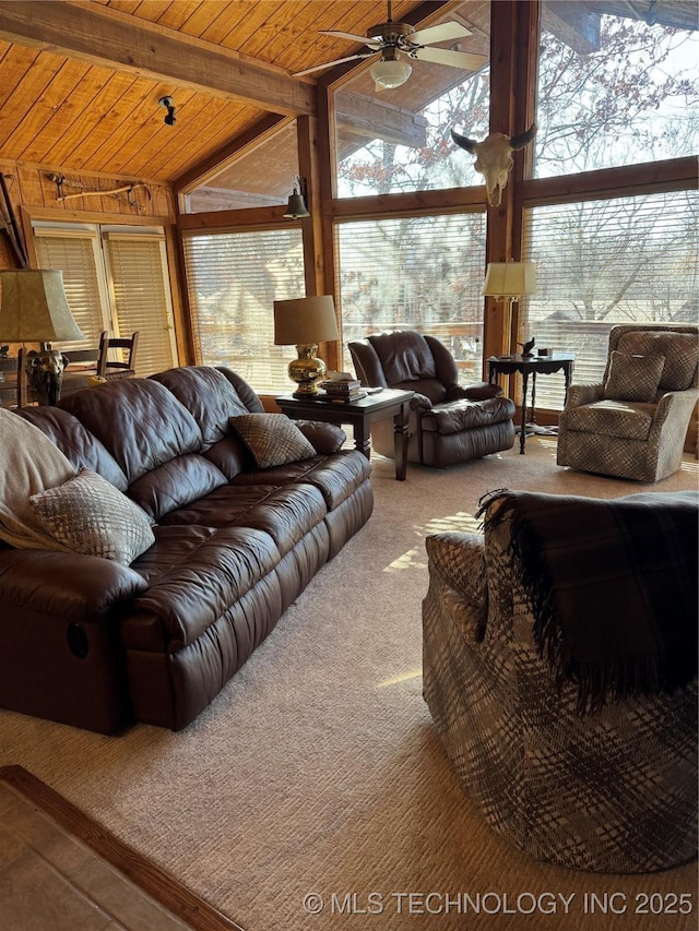 living area featuring lofted ceiling, plenty of natural light, wood ceiling, and carpet floors