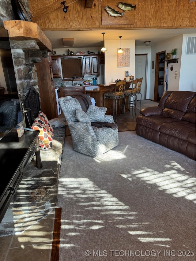 living room featuring visible vents and vaulted ceiling