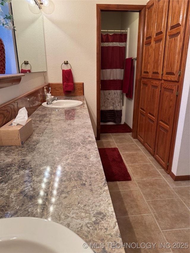 bathroom featuring a shower with curtain, vanity, and tile patterned floors