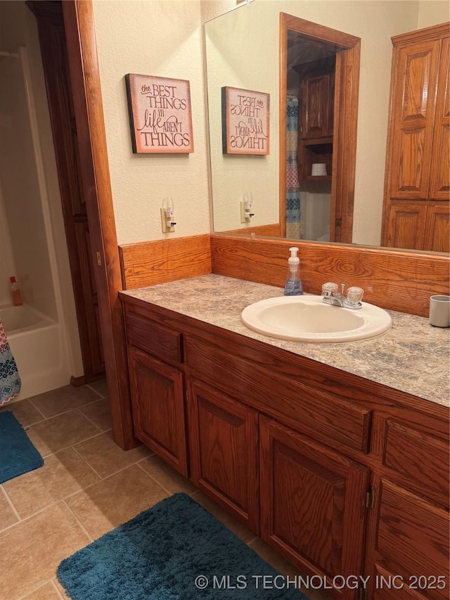 bathroom with a shower with shower curtain, a bathtub, vanity, and tile patterned floors