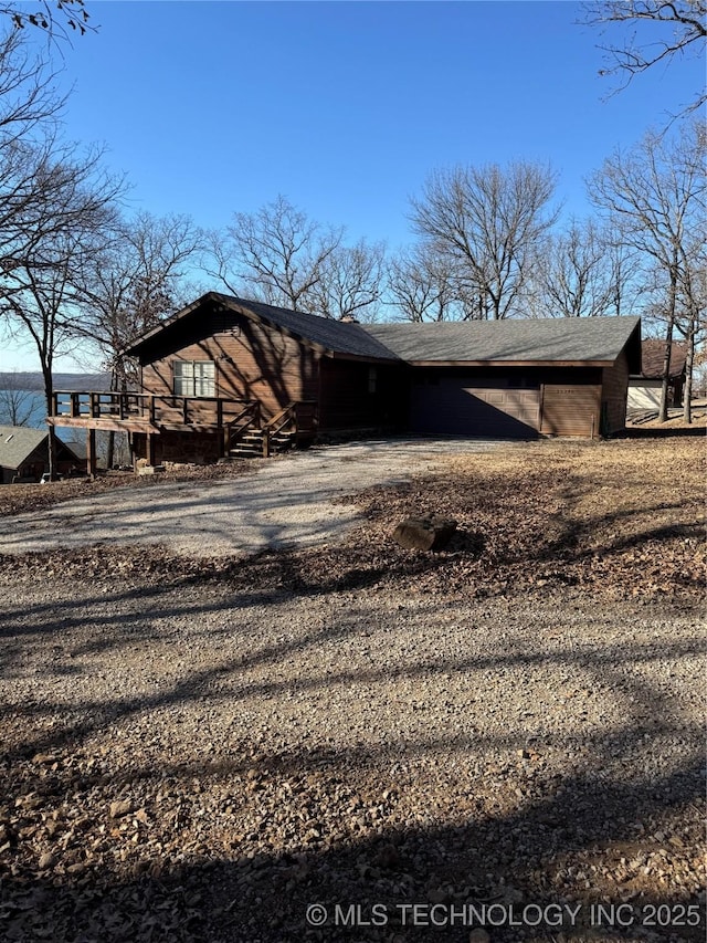 view of property exterior with driveway and a shingled roof