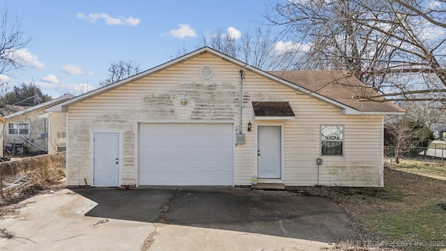 view of front of house with concrete driveway and fence